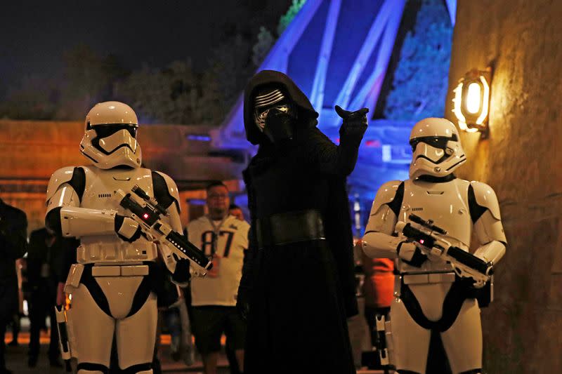 FILE PHOTO: People dressed as stormtroopers and the character Kylo Ren react at "Star Wars: Galaxy's Edge" at Disneyland Park in Anaheim