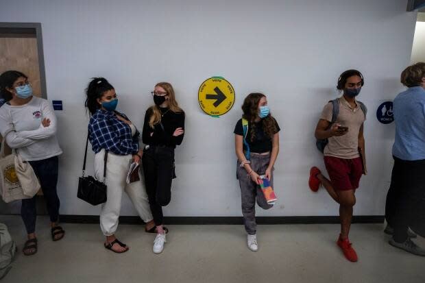 Students wait in long lines to cast their ballot at a polling station at the University of British Columbia in Vancouver on Monday.  (Ben Nelms/CBC - image credit)