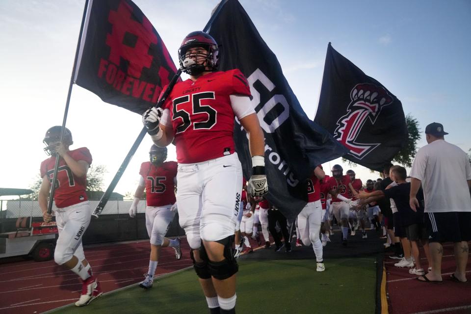 Liberty's Layton Vining (55) takes the field with his teammates before they play Pinnacle at Liberty High School in Peoria on Saturday, Sept. 10, 2022.