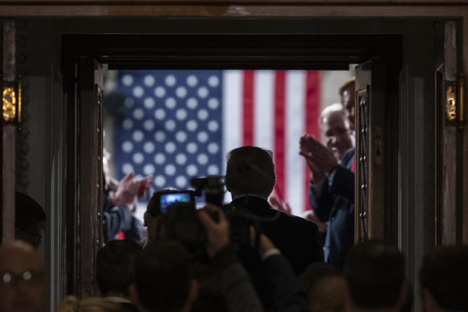 President Donald Trump enters the House floor where he will give his State of the Union address to a joint session of Congress in the House Chamber on Capitol Hill in Washington, Tuesday, Feb. 4, 2020. (AP Photo/Alex Brandon)