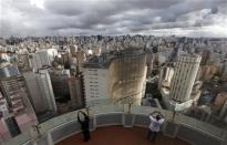 Tourists take photos of the city of Sao Paulo April 24, 2014. REUTERS/Paulo Whitaker