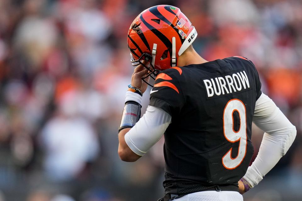 Cincinnati Bengals quarterback Joe Burrow (9) wipes his eyes between plays in the fourth quarter of the NFL Week 10 game between the Cincinnati Bengals and the Houston Texans at Paycor Stadium in downtown Cincinnati on Sunday, Nov. 12, 2023.