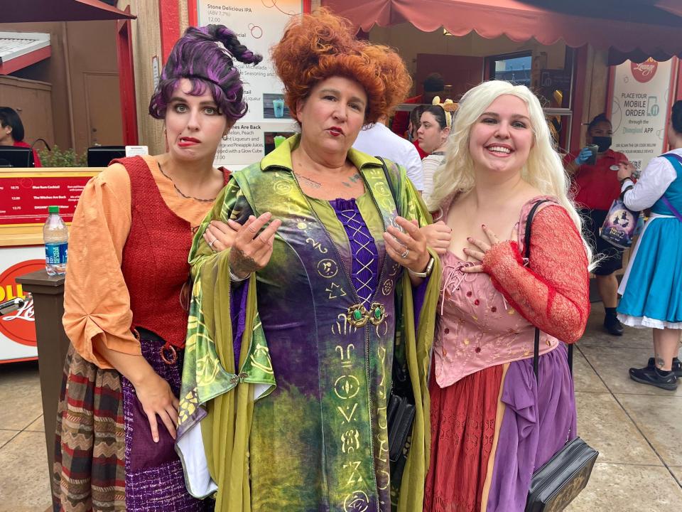 guests at oogie boogie bash dressed up as the sanderson sisters