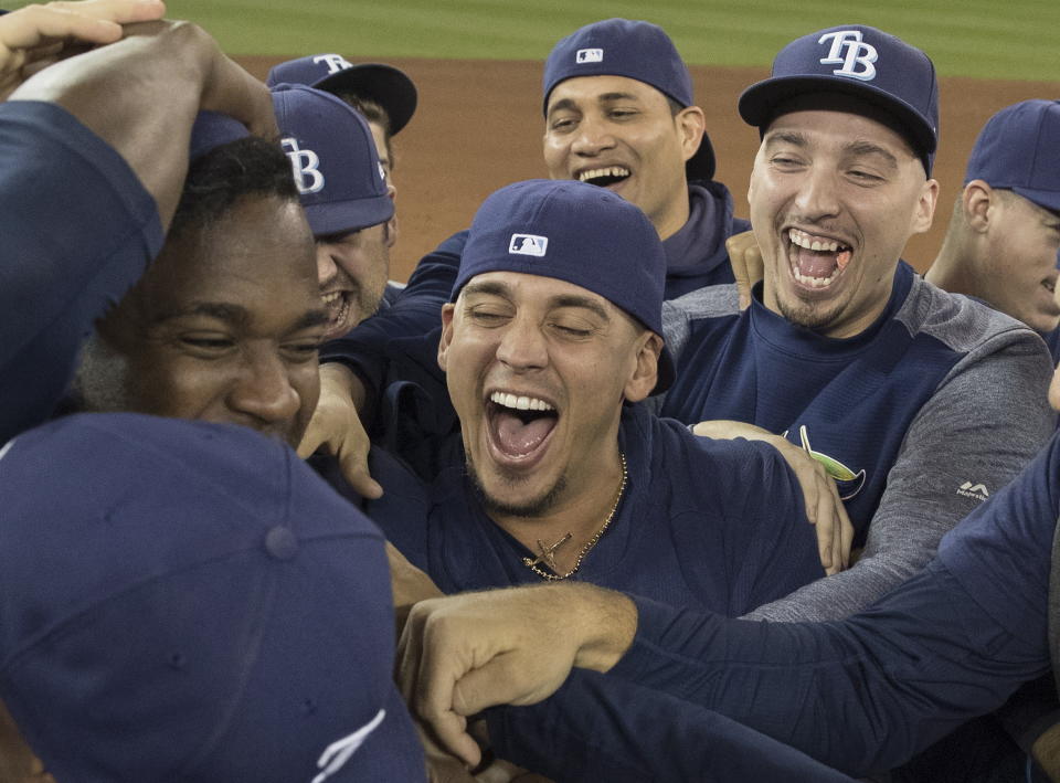 Tampa Bay Rays players celebrate on the field after they defeated the Toronto Blue Jays and clinched an MLB American League wild-card berth in Toronto, Friday, Sept. 27, 2019. (Fred Thornhill/The Canadian Press via AP)