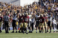 Missouri players celebrate as Boston College players look on after Missouri place kicker Harrison Mevis kicked a field goal to tie the game as time expired during the second half of an NCAA college football game, Saturday, Sept. 25, 2021, in Boston. (AP Photo/Mary Schwalm)