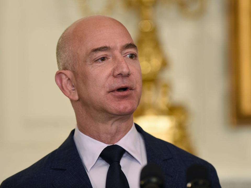 Jeff Bezos wearing suit looks into distance at White House event