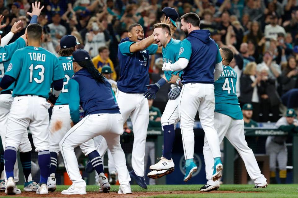 SEATTLE, WASHINGTON - SEPTEMBER 30: Cal Raleigh #29 of the Seattle Mariners celebrates his walk-off home run during the ninth inning against the Oakland Athletics at T-Mobile Park on September 30, 2022 in Seattle, Washington. With the win, the Seattle Mariners have clinched a postseason appearance for the first time  in 21 years, the longest playoff drought in North American professional sports. (Photo by Steph Chambers/Getty Images)