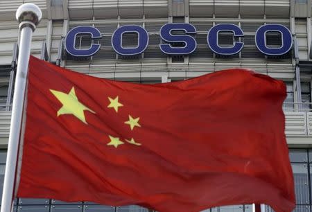 A Chinese national flag flies in front of COSCO's headquarters in Beijing August 26, 2010. REUTERS/Barry Huang