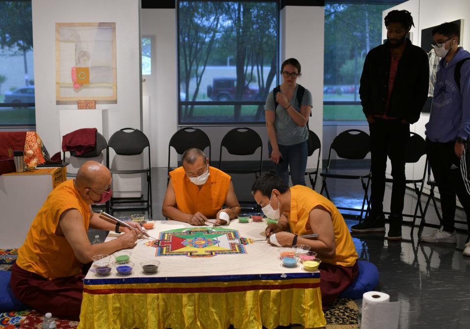 From left, Khenpo Tenzin Norgay Rinpoche, Lopen Rapjee Wangchuk and Lama Jigme Tenzin work on the sand mandala.