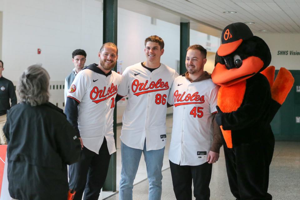 Nick Vespi, left, Coby Mayo (86), Keegan Akin (45) and the Oriole Bird pose for a photo during the Birdland Caravan fan rally at South Hagerstown High School on Saturday, Jan. 27, 2024.