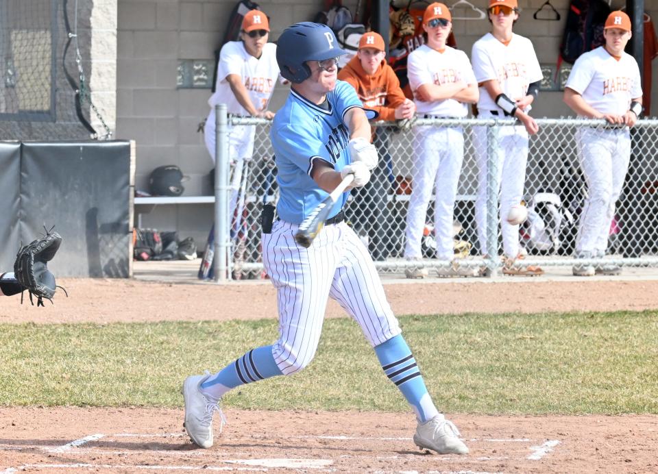 Petoskey's Tyler Goeldel swings into a pitch during the opening game against Harbor Springs Monday, which he went 3 for 3 in.