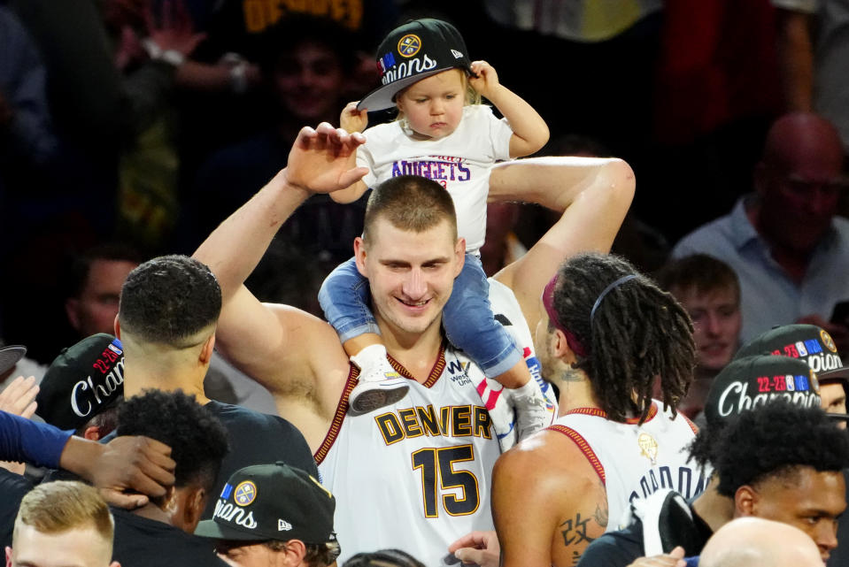 Denver Nuggets center Nikola Jokic (15) celebrates with his daughter after winning the 2023 NBA Championship against the Miami Heat at Ball Arena. (Ron Chenoy/USA Today Sports)