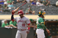 Los Angeles Angels' Juan Lagares reacts after striking out swinging against Oakland Athletics relief pitcher Lou Trivino in the ninth inning of a baseball game Wednesday, June 16, 2021, in Oakland, Calif. At right is Oakland Athletics catcher Aramis Garcia. (AP Photo/Eric Risberg)