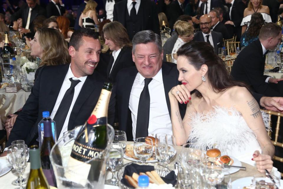 <p>Sharing a laugh with Adam Sandler and Netflix CEO Ted Sarandos at 2018's Critics' Choice Awards. </p>