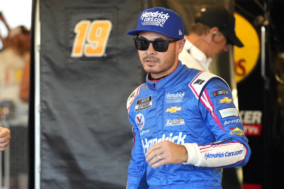 Kyle Larson walks after winning the pole for the NASCAR Cup Series auto race Saturday, Nov. 6, 2021, in Avondale, Ariz. (AP Photo/Rick Scuteri)