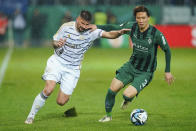 Saarbrucken's Kai Brunker, left, and Monchengladbach's Ko Itakura battle for the ball during the German Cup quarterfinal soccer match between FC Saarbrucken and Borussia Monchengladbach at Ludwigspark Stadium, Saarbrucken, Germany, Tuesday March 12, 2024. (Uwe Anspach/dpa via AP)