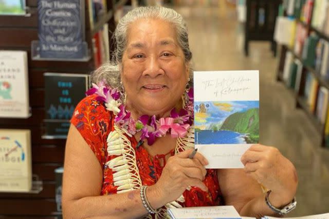 <p>Courtesy Lindamae Lawelawe</p> Lindamae Lawelawe and her book, "The Lost Children of Kalaupapa" by Lindamae Maldonado