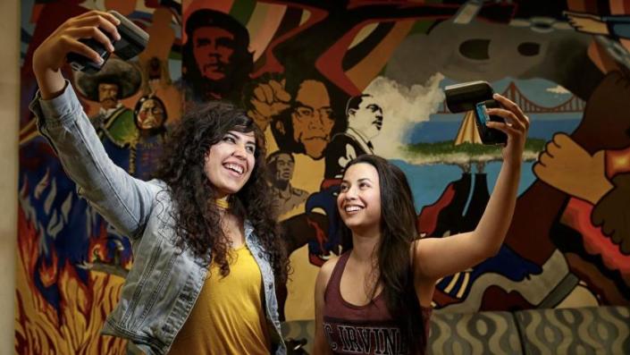 UC Irvine students Angela Vera, left, and Daniela Estrada are part of the growing Latino student population at the University of California. <span class="copyright">(Robert Gauthier / Los Angeles Times)</span>