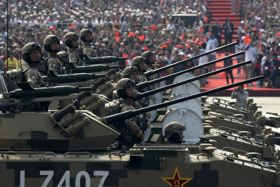 Military vehicles roll down during a parade to commemorate the 70th anniversary of the founding of Communist China in Beijing, Tuesday, Oct. 1, 2019. (AP Photo/Ng Han Guan)