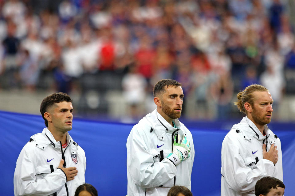 (LR) US No. 10 forward Christian Pulisic, US No. 01 goalkeeper Matt Turner and US No. 13 defender Tim Ream line up for the national anthem before the group C soccer match of the Copa America tournament. Conmebol 2024 between the USA and Bolivia at AT&T Stadium in Arlington, Texas, on June 23, 2024. (Photo by Aric Becker/AFP) (Photo by ARIC BECKER/AFP via Getty Images)