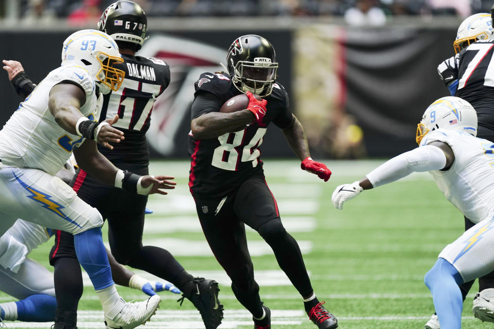 Atlanta Falcons running back Cordarrelle Patterson (84) runs between Los Angeles Chargers defensive tackle Otito Ogbonnia (93) and linebacker Kenneth Murray Jr. (9) during the first half of an NFL football game, Sunday, Nov. 6, 2022, in Atlanta. (AP Photo/John Bazemore)