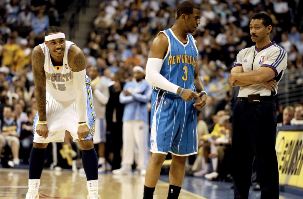 Denver Nuggets forward Carmelo Anthony (15), left, watches as New Orleans Hornets' guard Chris Paul (3),center, argues a call wi