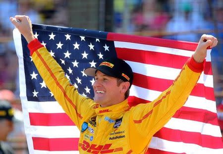 May 25, 2014; Indianapolis, IN, USA; IndyCar Series driver Ryan Hunter-Reay holds an American flag as he celebrates after winning the 2014 Indianapolis 500 at Indianapolis Motor Speedway. Mark J. Rebilas-USA TODAY Sports