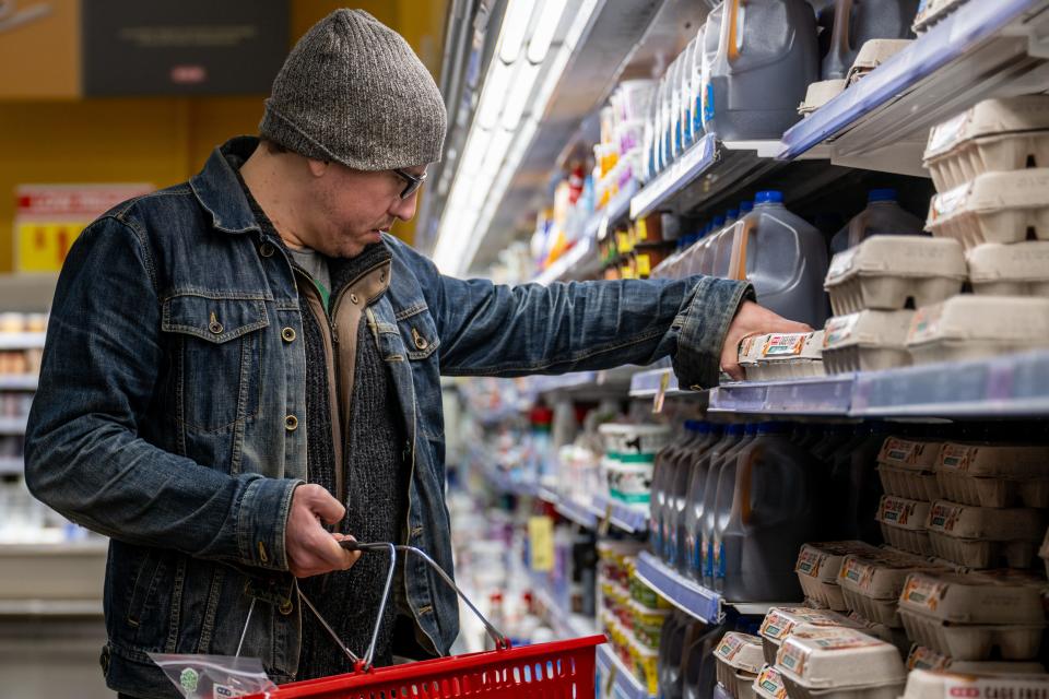 Shopper looking at eggs at a grocery store