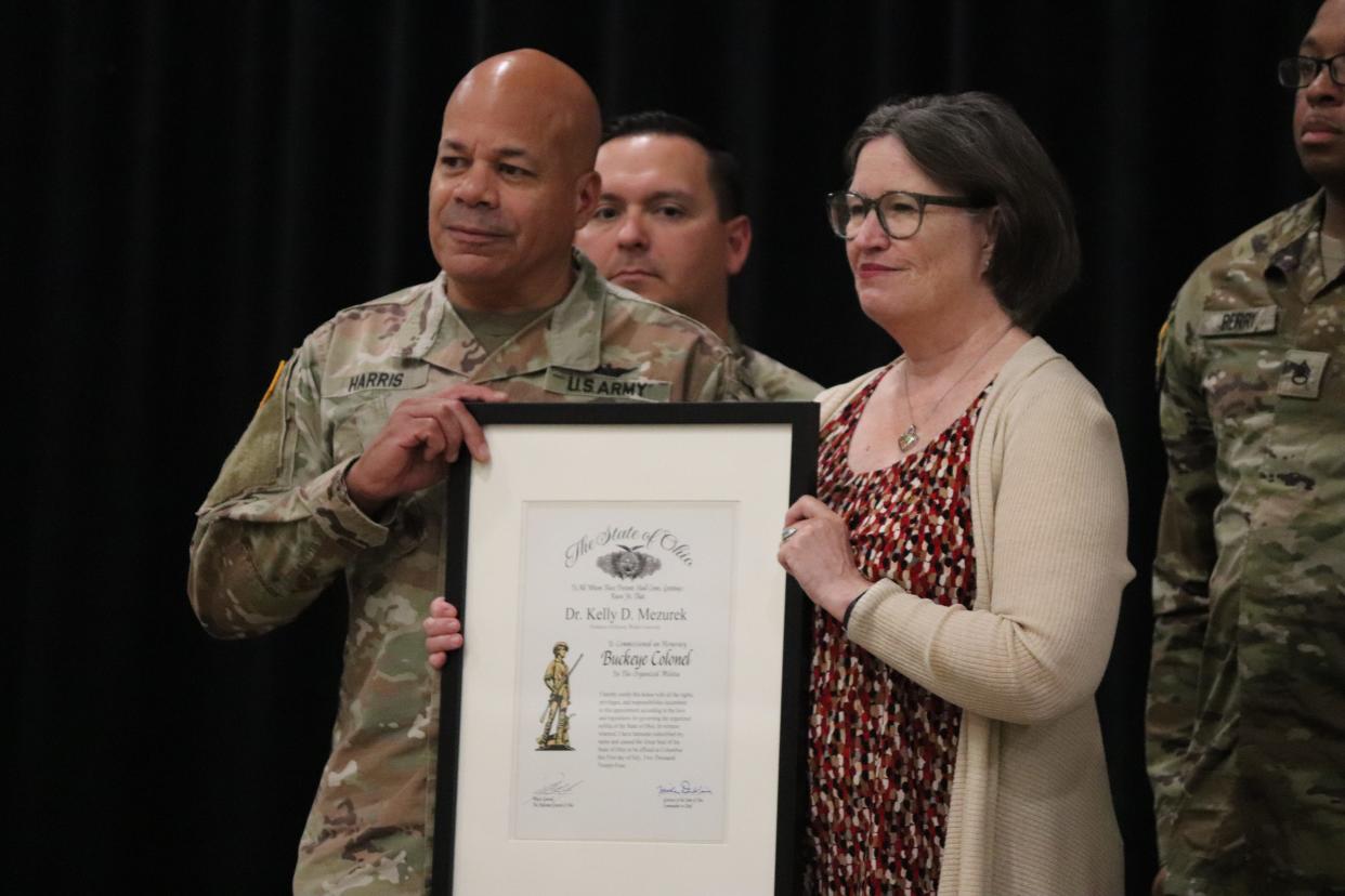 Kelly Mezurek, Walsh University professor of history and historian of 'colored troops,' receives an honorary Buckeye Colonel award from Ohio's Adjutant General John Harris. Photo taken June 1.