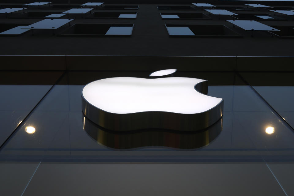 The logo of Apple is illuminated at a store in the city center in Munich, Germany, Wednesday, Dec. 16, 2020. Apple’s delayed launch of its latest iPhones unleashed a holiday buying frenzy that propelled sales of the trendsetting company’s most popular product to its fastest start in years. The apparently pent-up demand for four different iPhone 12 models highlighted Apple’s latest quarterly report Wednesday, Jan. 27, 2021. (AP Photo/Matthias Schrader)