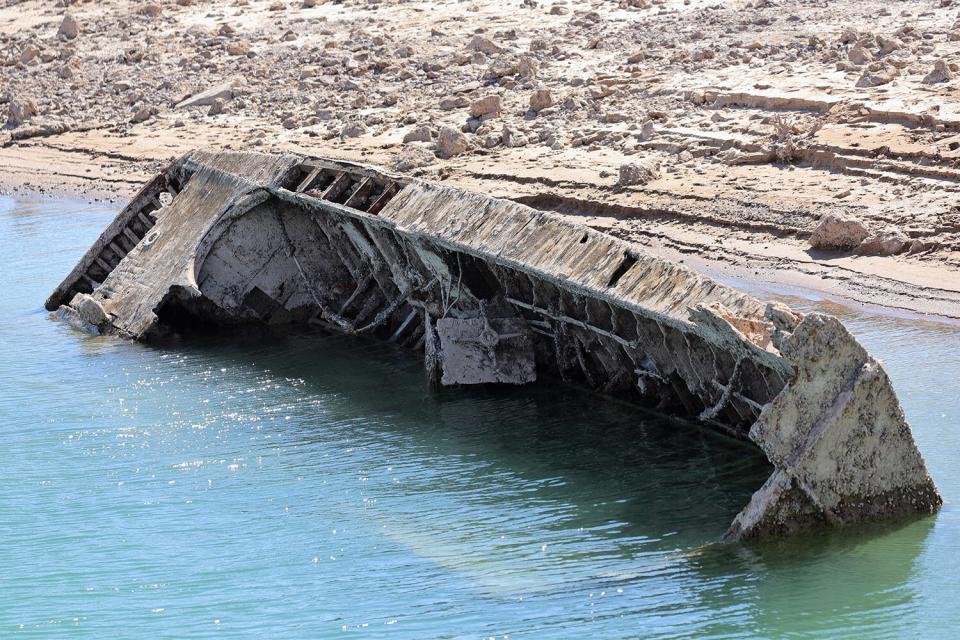 LAKE MEAD NATIONAL RECREATION AREA, NEVADA - JULY 01: A sunken World War II-Era Higgins landing craft that used to be nearly 200 feet underwater is being revealed near the Lake Mead Marina as the waterline continues to lower on July 01, 2022 in the Lake Mead National Recreation Area, Nevada. The water level at Lake Mead is at its lowest since being filled in 1937 after the construction of the Hoover Dam as a result of a climate change-fueled megadrought coupled with increased water demands in the Southwestern United States. (Photo by Ethan Miller/Getty Images)