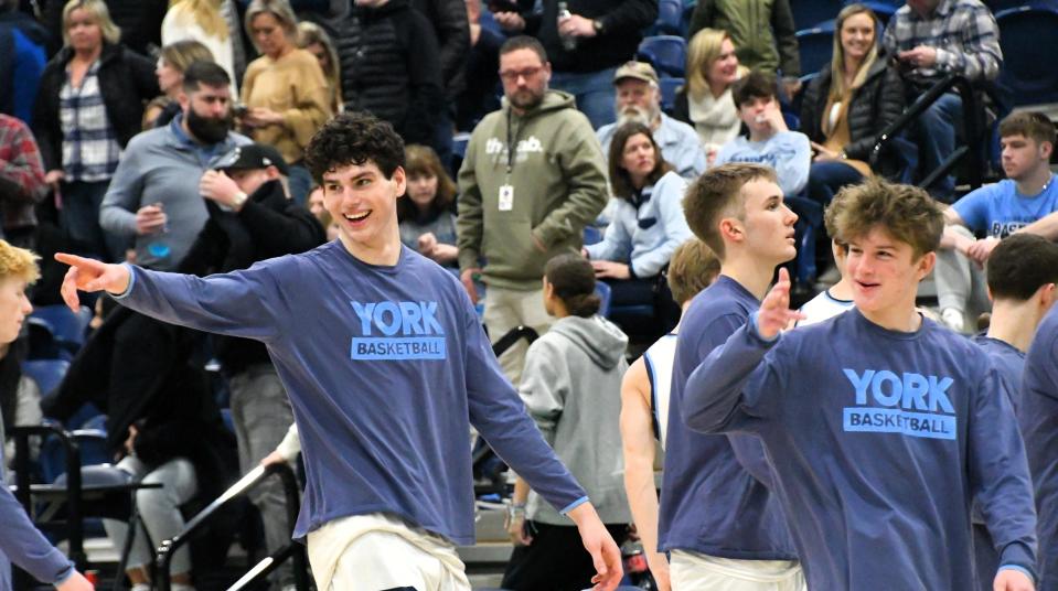 York’s Lukas Bouchard, left, happily acknowledges some fans after his team won its Class B South quarterfinal game over Spruce Mountain on Friday.