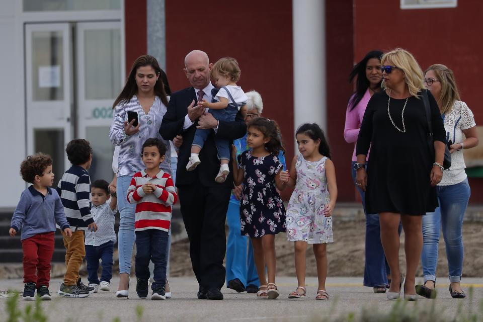 EDS NOTE : SPANISH LAW REQUIRES THAT THE FACES OF MINORS ARE MASKED IN PUBLICATIONS WITHIN SPAIN. Accompanied by family members, former Venezuelan military spy chief, retired Maj. Gen. Hugo Carvajal, center, walks out of prison in Estremera, outskirts of Madrid, Spain, Sunday, Sept. 15, 2019. Spain's National Court on Monday rejected the extradition to the United States of a former Venezuelan military spy chief accused of drug smuggling and other charges. (AP Photo/Manu Fernandez)