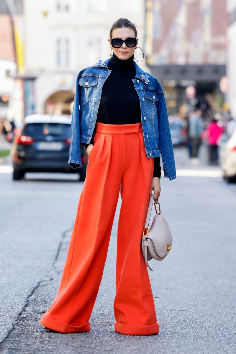 <p> One of the pros of a denim jacket is that it can be the star of the show or take a supporting role and let other pieces shine. The bold orange trousers really pop against the blue denim and the black roll neck provides the perfect foundation. Minimal styling is needed - just some dramatic hoops and an everyday bag. </p>