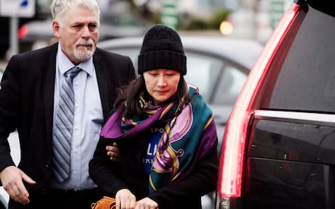 Huawei chief financial officer Meng Wanzhou arrives at a parole office with a security guard in Vancouver, British Columbia, Wednesday, Dec. 12, 2018 - Credit: &nbsp;Darryl Dyck/Canadian Press