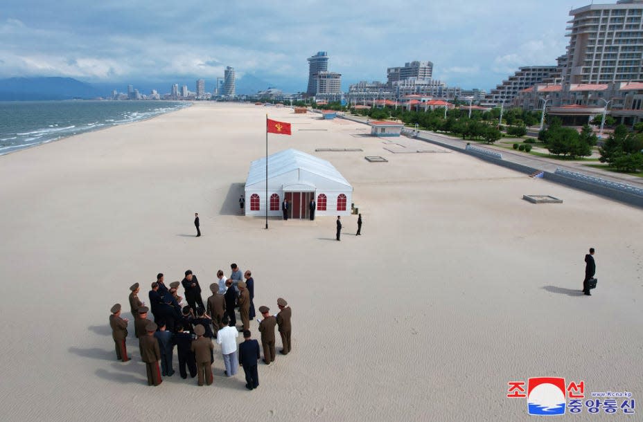 Kim Jong Un on a beach with his deputies