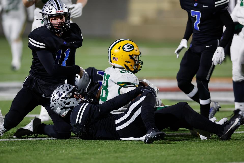 Hilliard Bradley’s Drew Williams (2) tackles Lakewood St. Edward’s Brandon White (28) during the state semifinal.