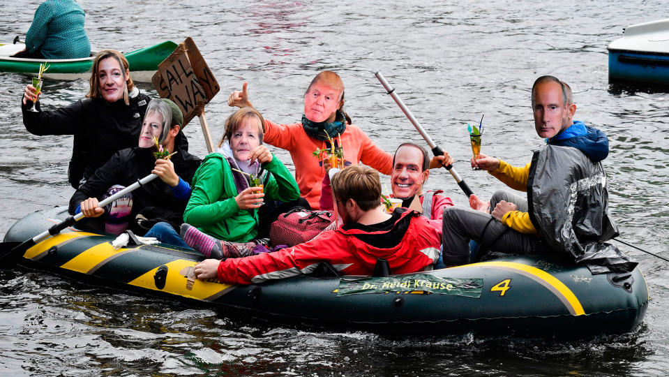 <p>JUL. 2, 2017 – Protestors with masks of politicians drink cocktails in a boat on the Alster river during a demonstration called by several NGOs ahead of the G20 summit in Hamburg. (Photo: John MacDougall/AFP/Getty Images) </p>