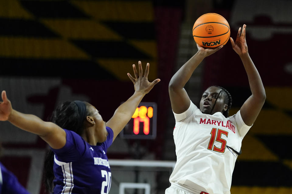 Maryland guard Ashley Owusu (15) shoots against Northwestern forward Paige Mott (20) during the second half of an NCAA college basketball game, Sunday, Jan. 23, 2022, in College Park, Md. Maryland won 87-59. (AP Photo/Julio Cortez)