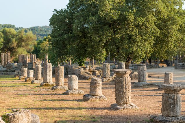 <p>Stefan Cristian Cioata/Getty Images</p> Ancient ruins and columns at Olympia archaeological site in Greece