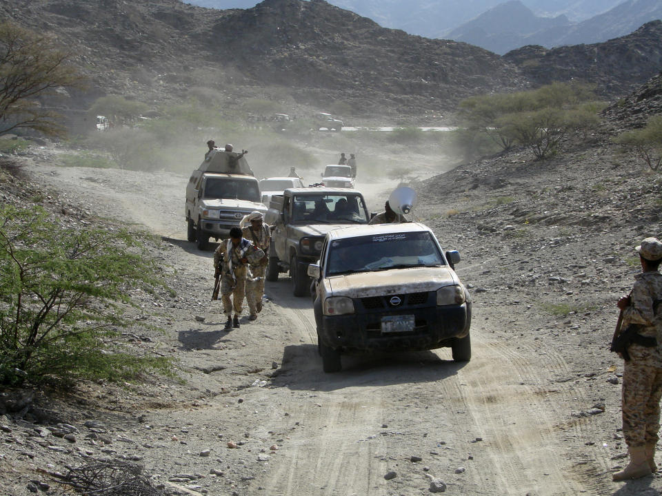 In this Monday, May 5, 2014 photo provided by Yemen's Ministry of Defense, Yemeni troops take position at the frontline of fighting with al-Qaida militants in the province of Shabwa, Yemen. Yemeni troops seized two al-Qaida strongholds in the country's south after a days-long offensive that left dozens of suspected militants and troops dead, the country's Defense Ministry said Tuesday. (AP Photo/Yemen Defense Ministry)