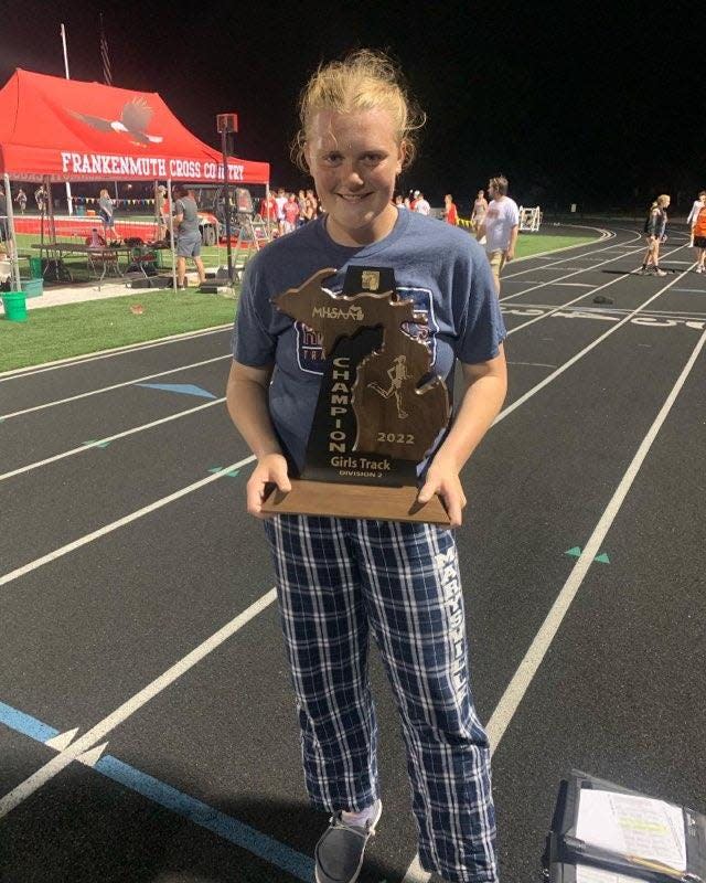 Marysville's Janae Hudson holds a Division 2 regional championship trophy at Frankenmuth High School on Friday, May 20, 2022. Hudson won the discus and shot put while setting personal records in both.