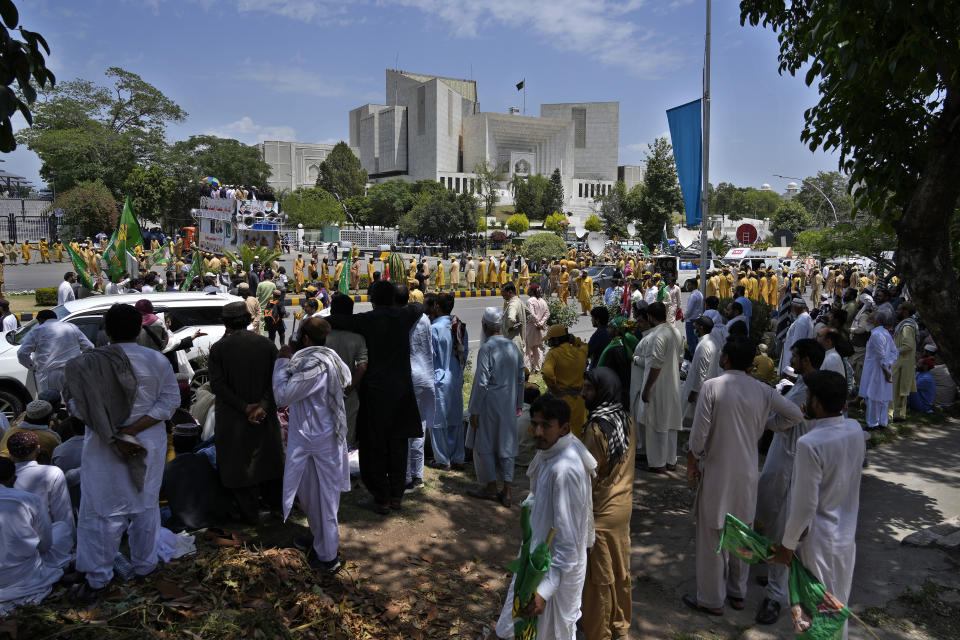 Supporters of Pakistan Democratic Movement, an alliance of the ruling political parties, take part in a rally outside the Supreme Court in Islamabad, Pakistan, Monday, May 15, 2023. Convoys of buses and vehicles filled with Pakistani pro-government supporters are flooding the main road leading to the country's capital on Monday to protest the release of former Prime Minister Imran Khan. (AP Photo/Anjum Naveed)