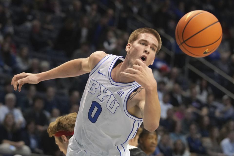 BYU forward Noah Waterman reaches for a rebound during game against Denver, Wednesday, Dec. 13, 2023, in Provo, Utah. | George Frey, Associated Press