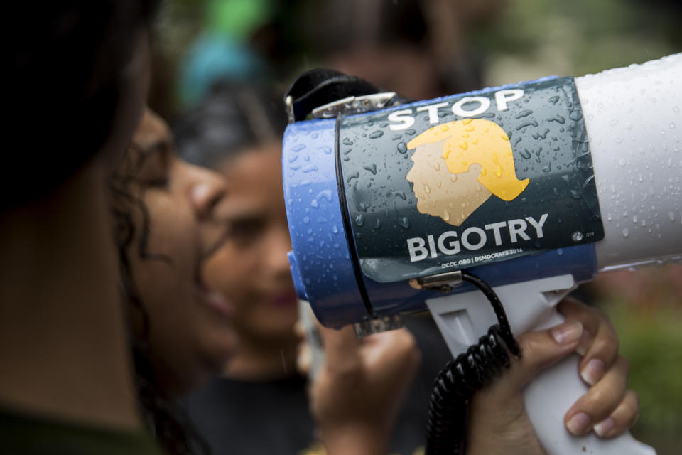 <p>A demonstrator holds a megaphone with a sticker that reads “Stop Bigotry” during a protest against detaining and separating immigrant families outside of the Immigration and Customs Enforcement (ICE) headquarters in Washington, D.C., on Wednesday, June 27, 2018. (Photo: Andrew Harrer/Bloomberg via Getty Images) </p>