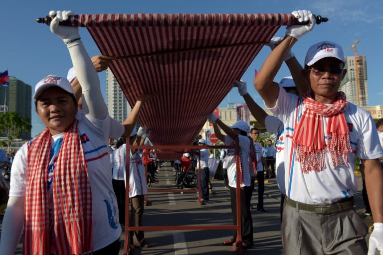 Thousands of young people then rolled out the krama along a street in the capital Sunday for a visiting Guinness official to measure the garment