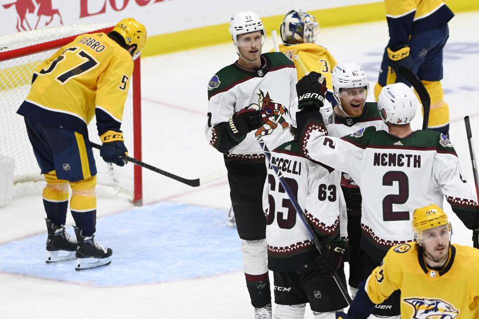 Arizona Coyotes left wing Lawson Crouse (67) celebrates with teammates after his goal during the third period of an NHL hockey game against the Nashville Predators, Monday, Feb. 13, 2023, in Nashville, Tenn. (AP Photo/Mark Zaleski)