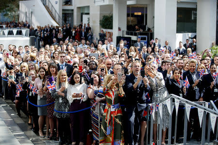 Employees take photographs as Britain's Queen Elizabeth visits the headquarters of British Airways, as British Airways mark their centenary year, in Heathrow, west London, Britain May 23, 2019. Tolga Akmen/Pool via REUTERS