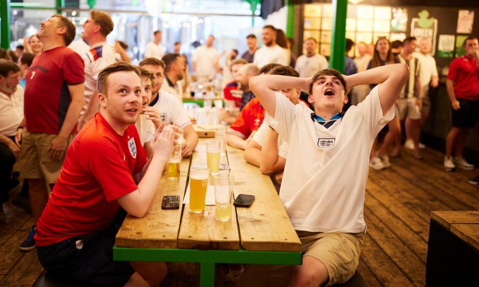 <span>Fans watching England v Slovenia at the Green Duck Beer Company in Stourbridge.</span><span>Photograph: Christopher Thomond/The Guardian</span>