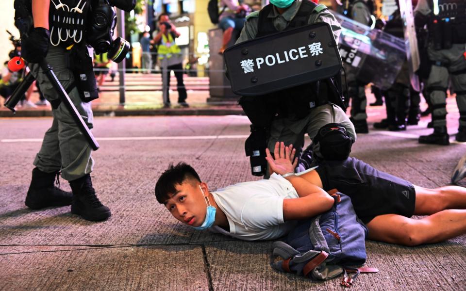 Police officers detain protesters during a rally against a new national security law - MIGUEL CANDELA/EPA-EFE/Shutterstock